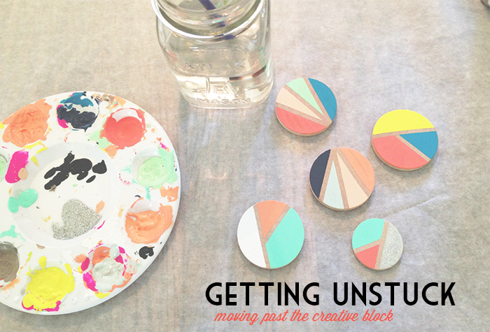 Paint palette, hand painted wood circle brooches in geometric design, title in lower right says Getting Unstuck moving past the creative block